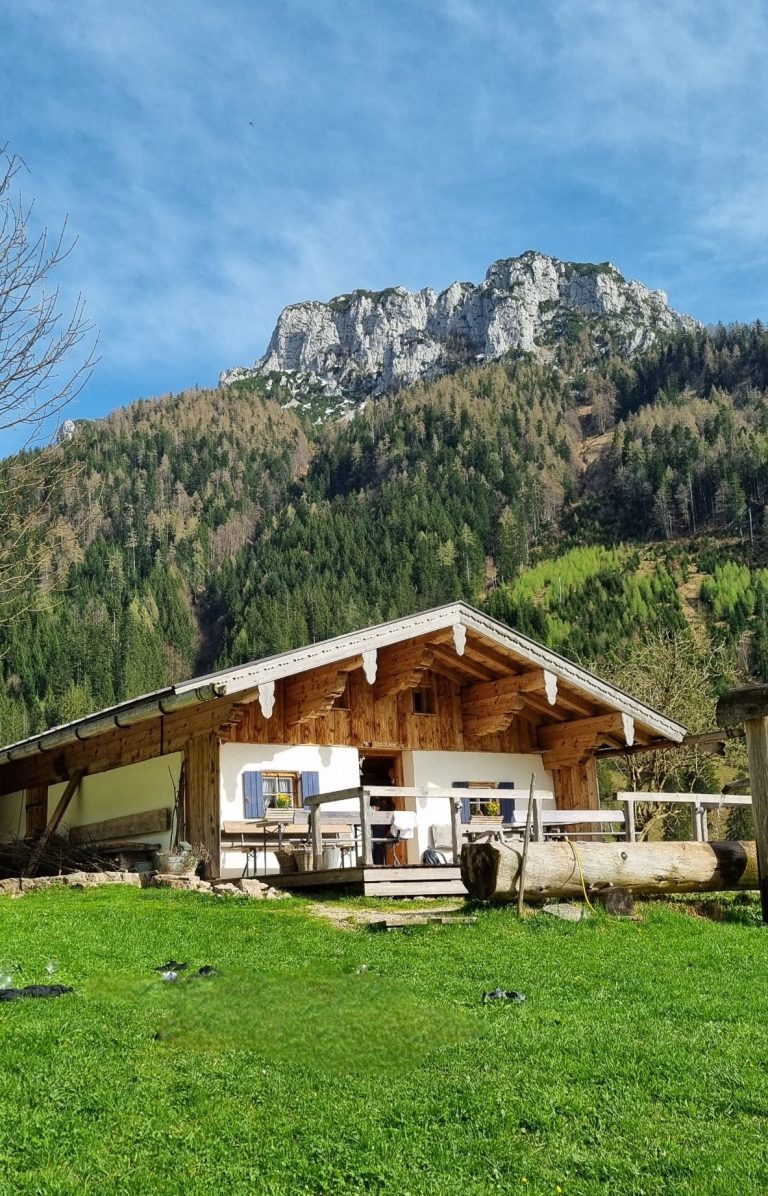 Zwei Kinder sitzen meditierend in einer bunten Wiese mit Schmetterlingen und Blumen.
